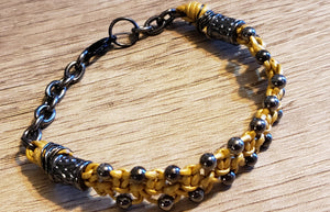 Metallic Gold Leather Bracelet with Black Czech Glass Beads & Hemotite colored Stainless Steel Chain, Adjustable up to 7.5" with Lobster Claw Clasp.
 